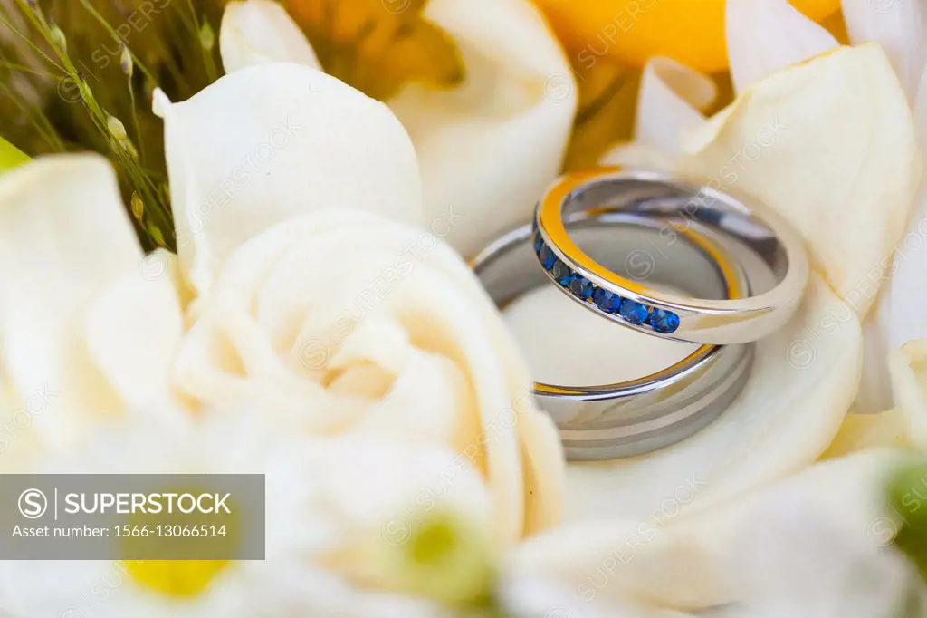 Wedding rings in a flower during a reception, showing the commitment and love of the bride and groom.