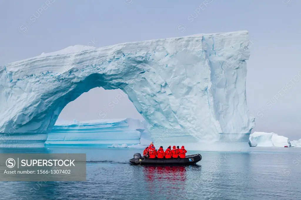 Guests from the Lindblad Expedition ship National Geographic Explorer enjoy icebergs at Booth Island, Antarctica by Zodiac.