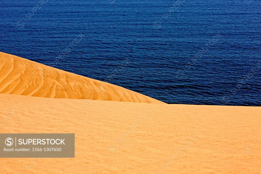 Sand Dunes and Ocean near Walvis Bay, Desert in Namibia.