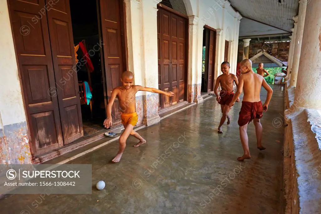 Myanmar (Burma), Mon state, Mawlamyine (Moulmein), young monk playing soccer.