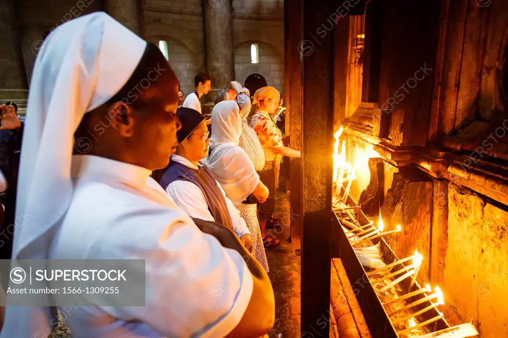 People at the church of the Holy Sepulchre in the old city, Jerusalem, Israel.
