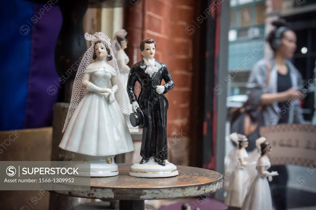 Figurines of brides and grooms for both heterosexual and gay marriages are seen in a store window in New York