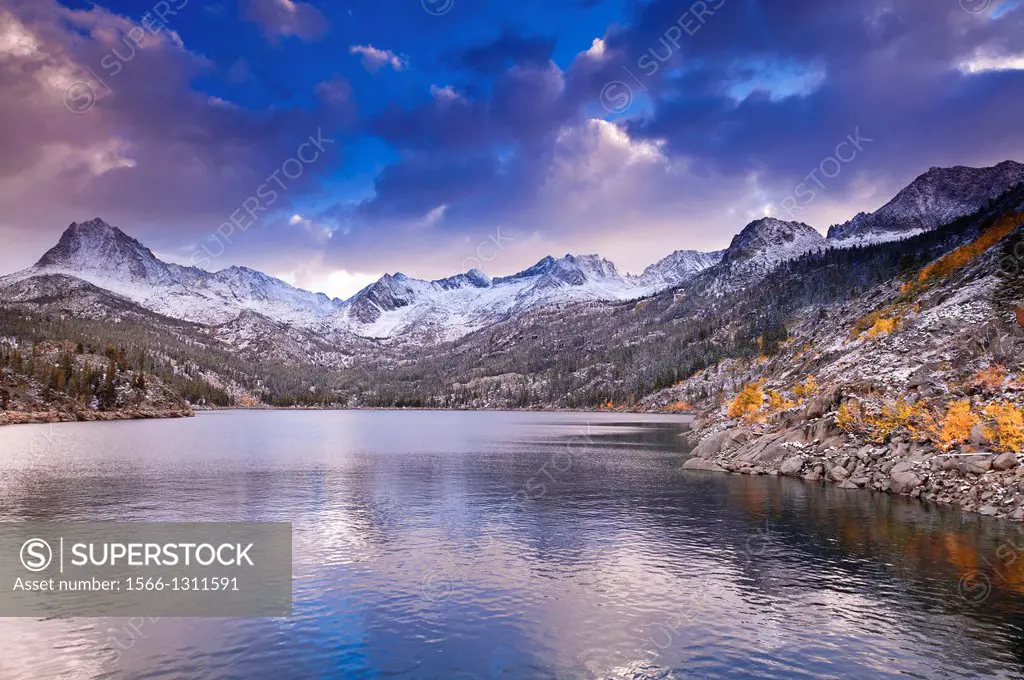 Fall aspens under Sierra peaks from South Lake, John Muir Wilderness, Sierra Nevada Mountains, California USA.