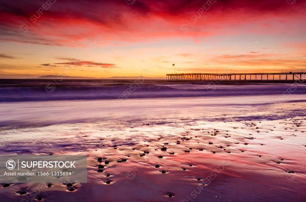 Sunset over the Channel Islands and Ventura Pier from San Buenaventura State Beach, Ventura, California USA.