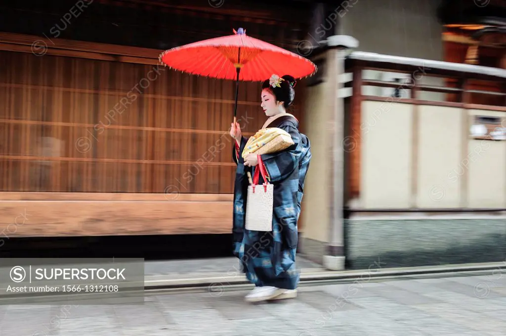 Maiko going to work under the rain, Kyoto, Japan.