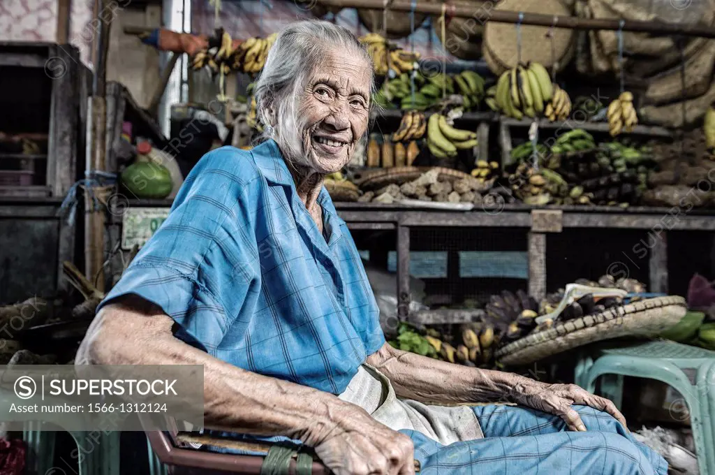 Old fruit seller waiting for clients, Romblon, Philippines, Asia.