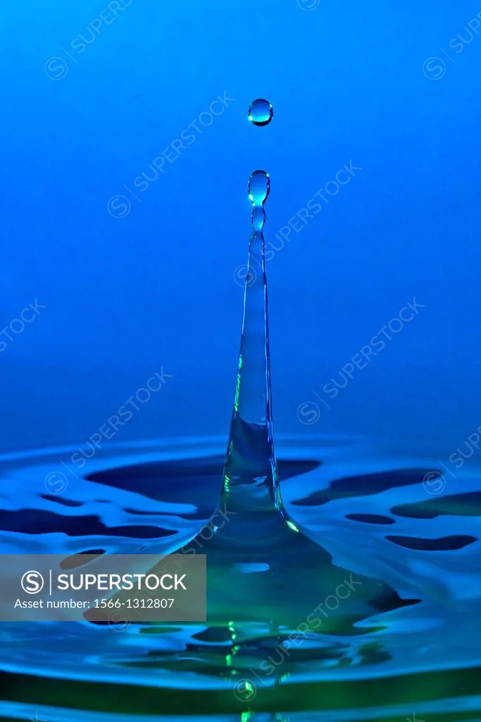 High-speed photograph of a water drop impacting on water showing secondary drops formation.