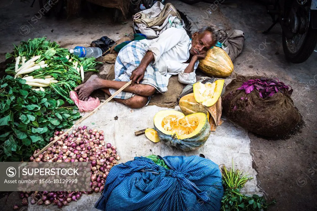 Vegetables vendor sleeping at his stall in Varanasi, India.