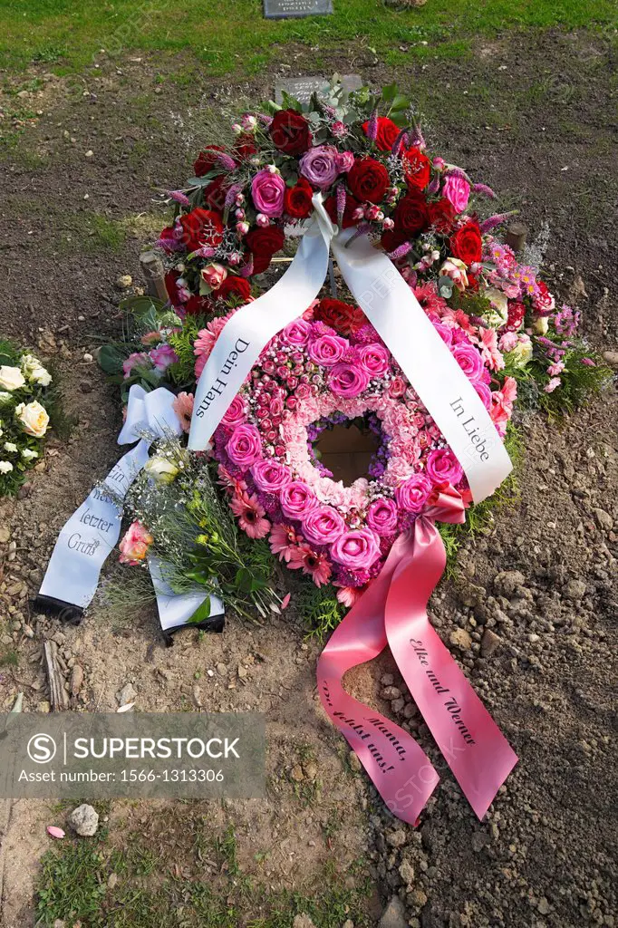 churchyard, death, mourning, entombment, grave, urn tomb, flowers, roses, wreath, coronal, floral arrangement, ribbons.