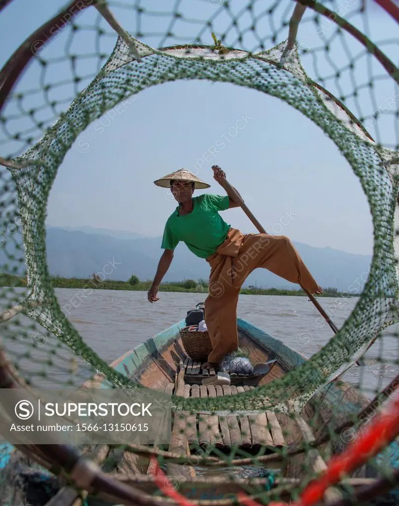 A fisherman poses for tourists on Inle Lake.