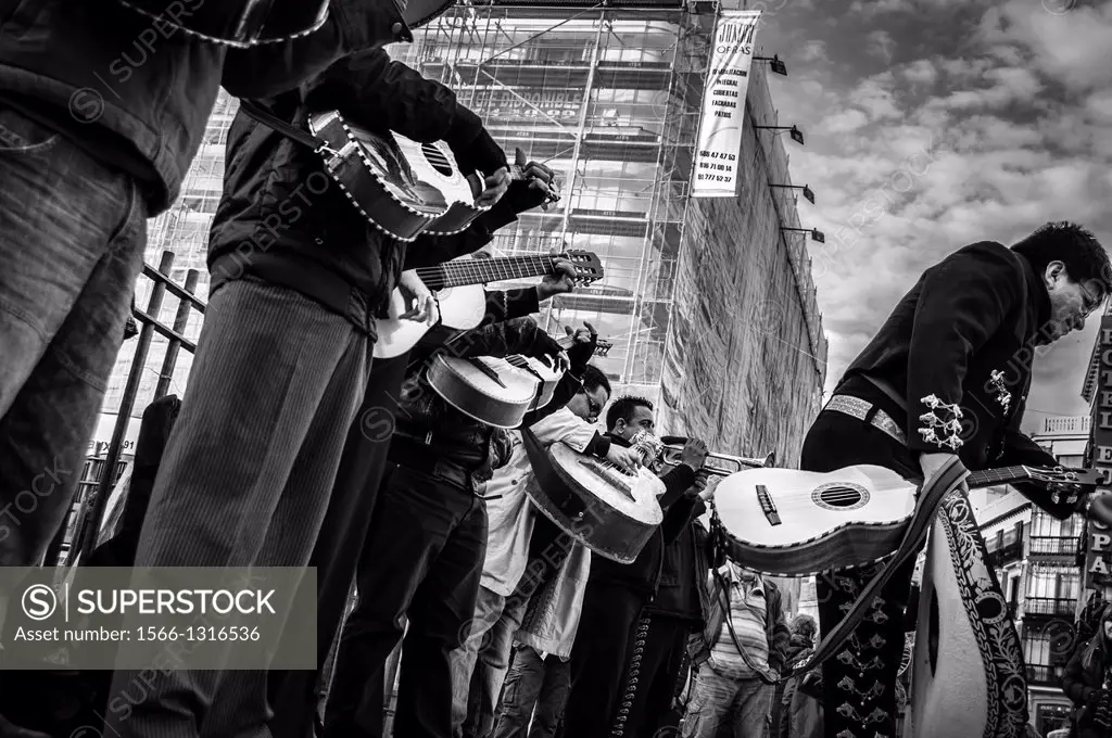 A mariachi leans over to greet the audience after the performance at the Puerta del Sol in Madrid, Spain