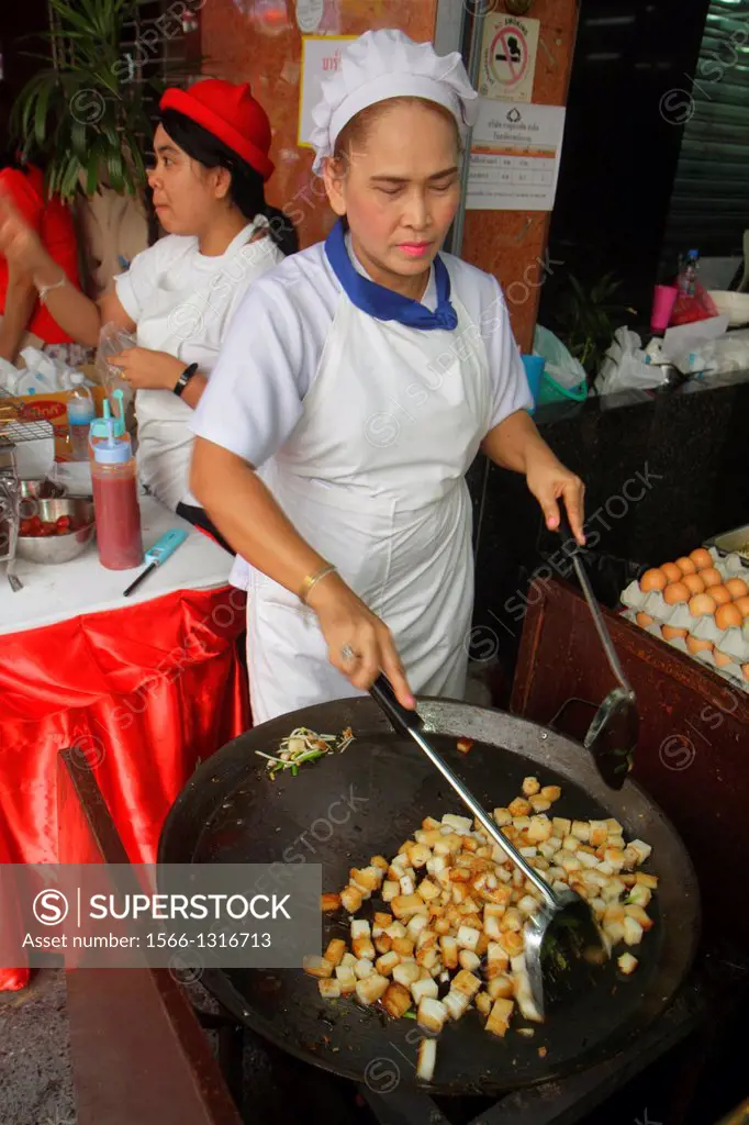 Thailand, Bangkok, Samphanthawong, Chinatown, Yaowarat Road, Asian, woman, cook, chef, street food vendor, cooking, preparing, uniform.
