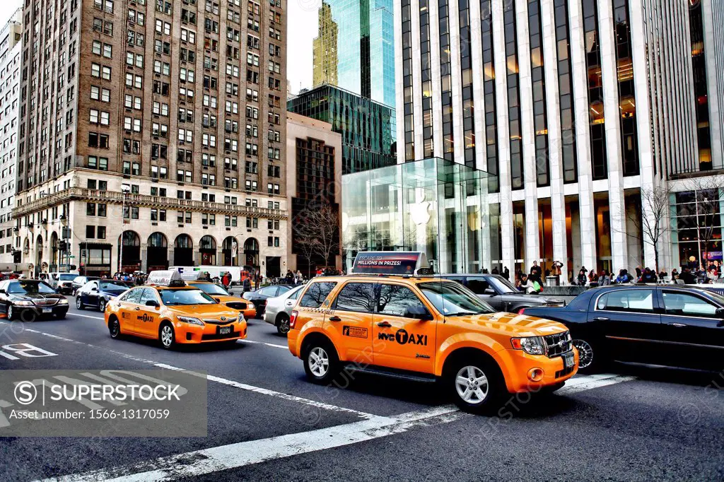 Traffic and Taxis Driving Down Fifth Avenue at 58th Street, New York, NY, USA.