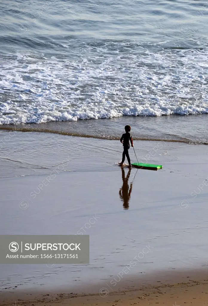 little boy in wetsuit with surfboard, Beliche Beach, Algarve, Portugal, Europe,