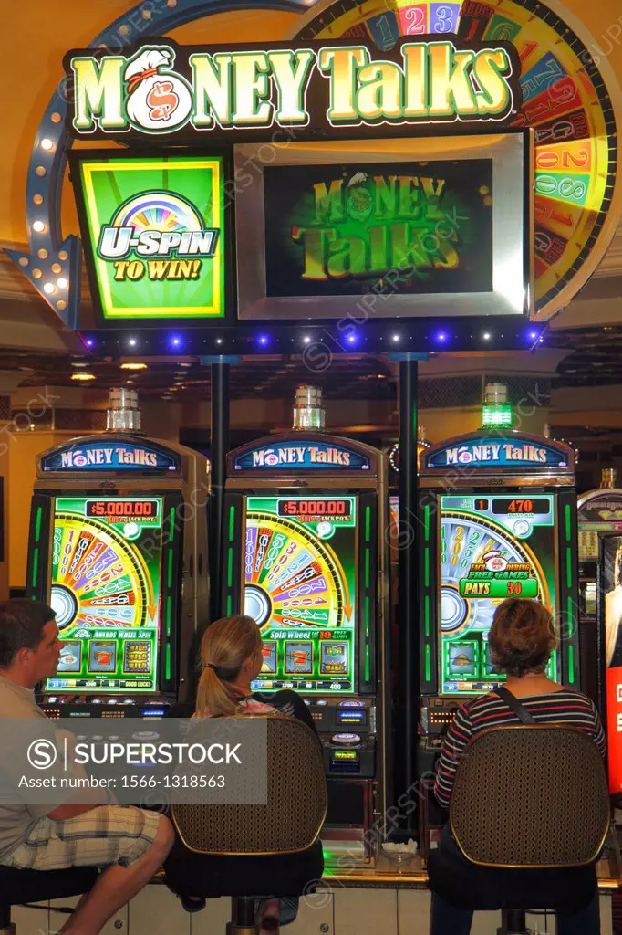 Nevada, Las Vegas, The Strip, South Las Vegas Boulevard, Harrah's Las Vegas Hotel, casino, gambler, gambling, slot machine, machines, man, woman,.