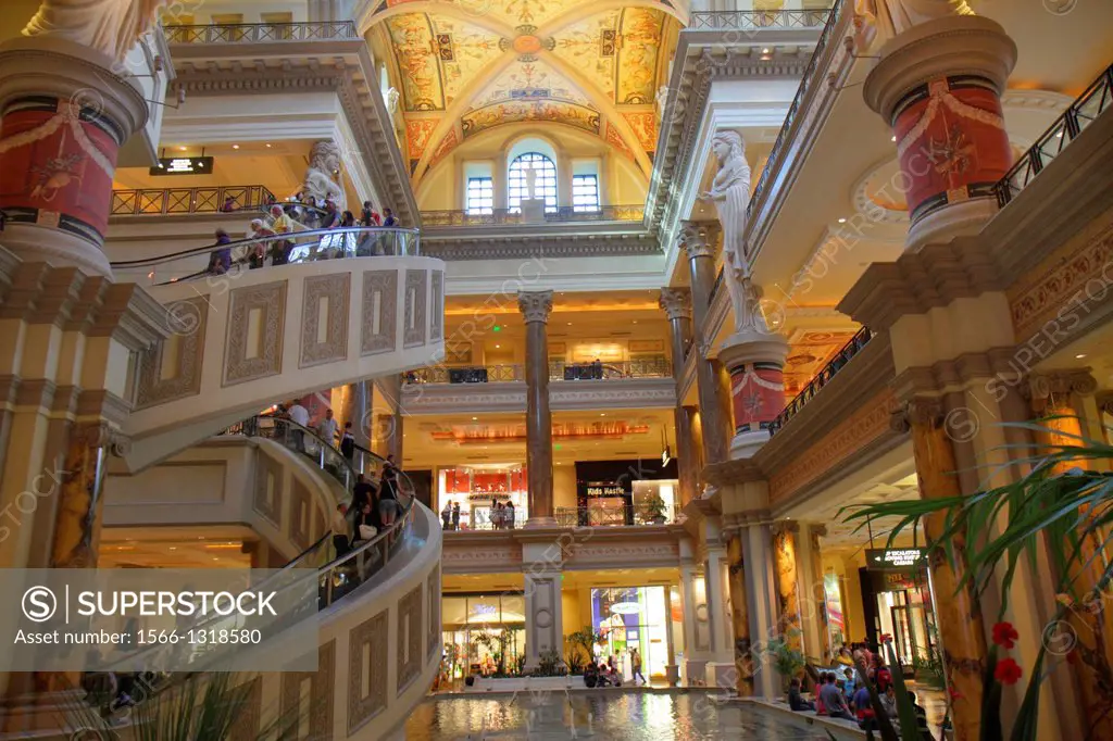 Nevada, Las Vegas, The Strip, South Las Vegas Boulevard, Forum Shops at Caesars Palace, shopping, escalator, shoppers, statue, interior.
