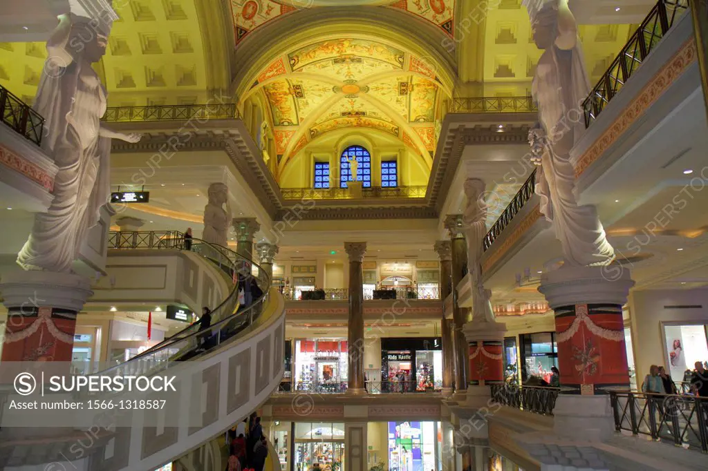 Nevada, Las Vegas, The Strip, South Las Vegas Boulevard, Forum Shops at Caesars Palace, shopping, escalator, shoppers, statue, interior.