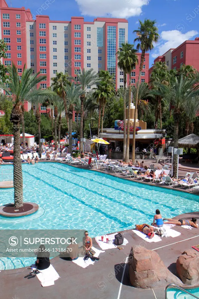 Nevada, Las Vegas, The Strip, South Las Vegas Boulevard, Flamingo Las Vegas Hotel and Casino, swimming pool area, sunbathers, guests.