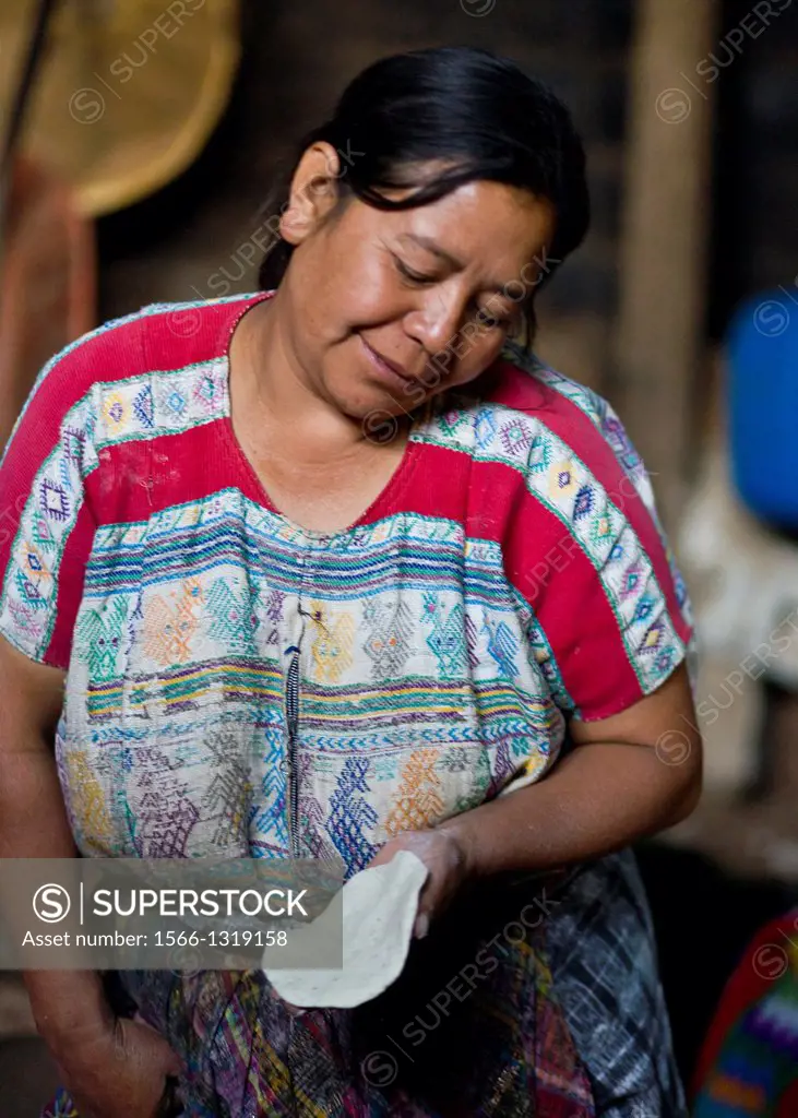 Guatemala, San Jose Poaquil, woman making tortillas.