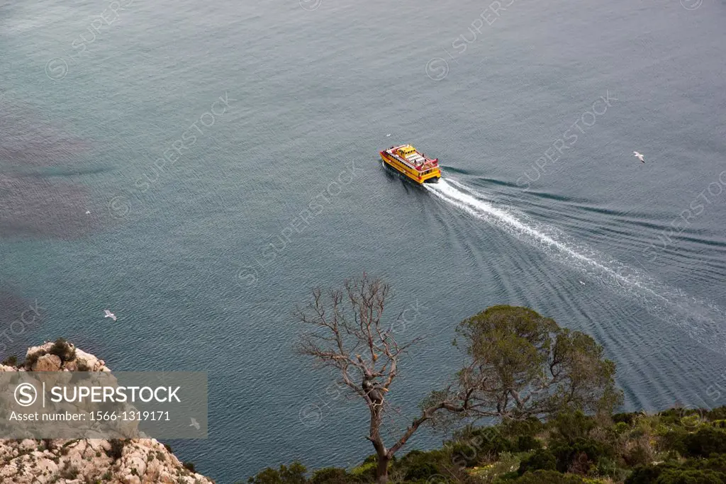 sightseeing boat surrounding the Rock of Ifach, Calpe, Alicante, Spain.