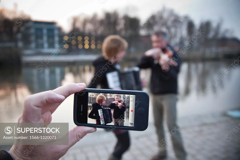 Live music of a violin and accordion duo on the banks of the canal in Lübeck. Lubeck, Schleswig-Holstein, Germany.