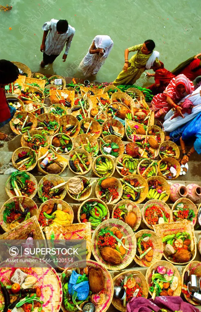 women ritual were fruit is offered to the Gods in the Ganges in Varanasi, India