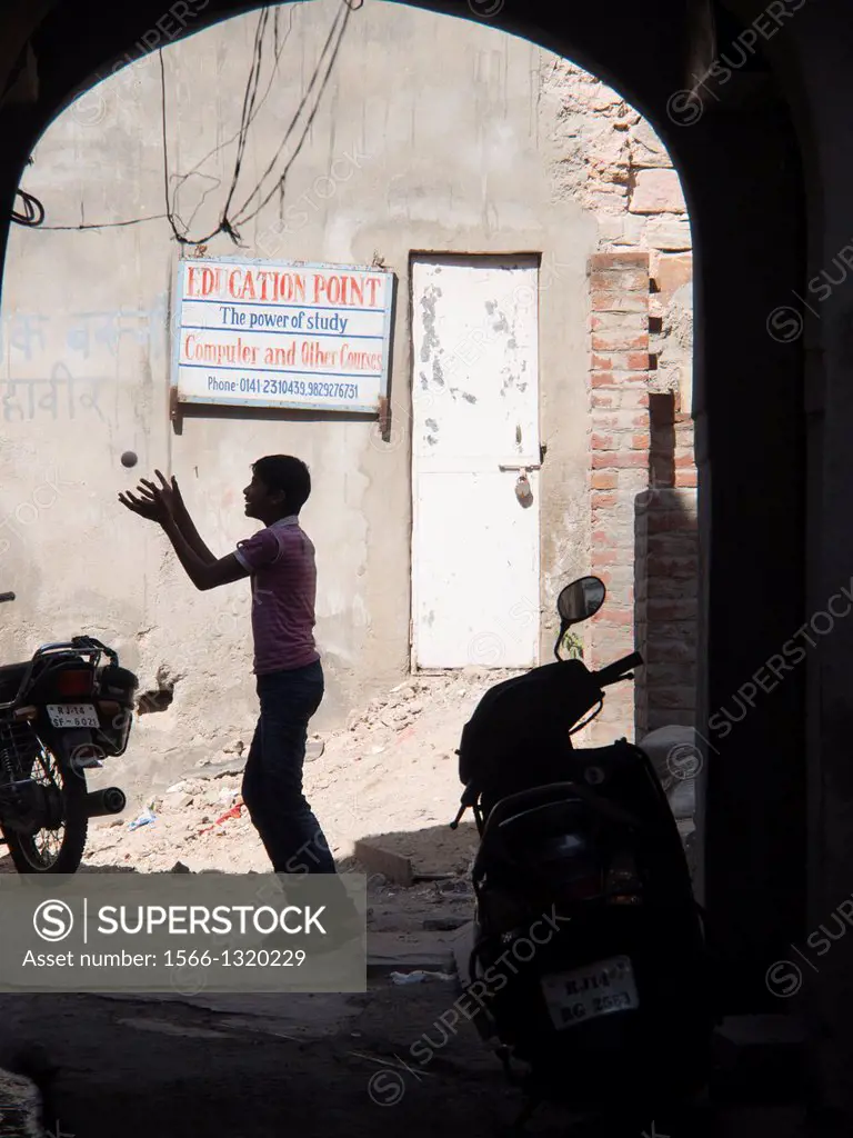 Silhouette of boy playing in front of an education center in Jaipur, Rajasthan, India.