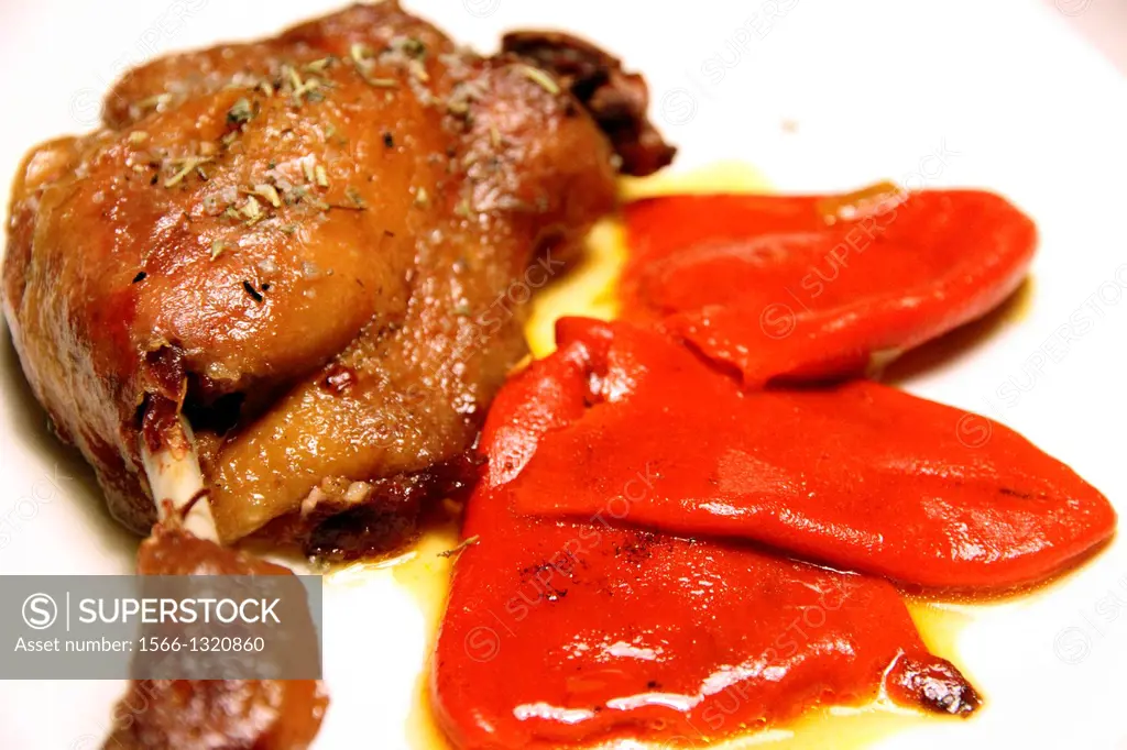Duck confit , Roasted duck leg with red piquillo peppers.