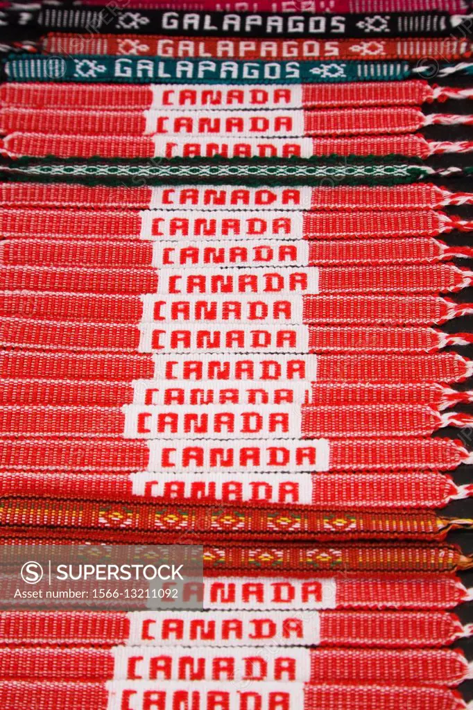 Close-up of red and white Canada cloth material bracelets for sale and displayed on a black background at an outdoor market, Byward Market, Ottawa, On...