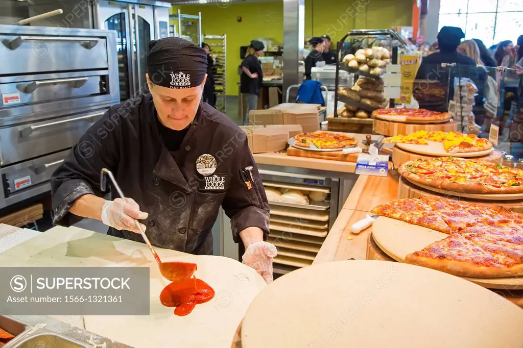 Detroit, Michigan - A worker makes pizza at a Whole Foods Market on the day of the store's opening in midtown Detroit. Whole Foods is the first major ...
