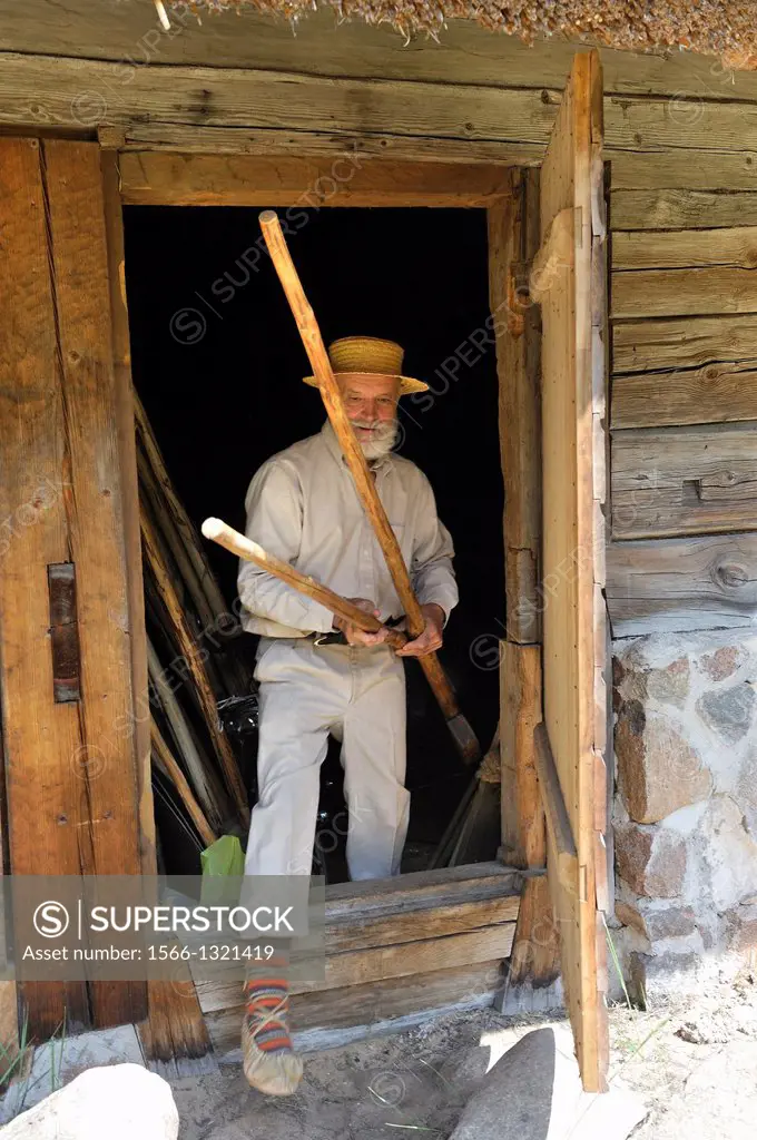 old man cabinetmaker showing his products in the village of Kurzeme, Ethnographic Open-Air Museum around Riga, Latvia, Baltic region, Northern Europe.