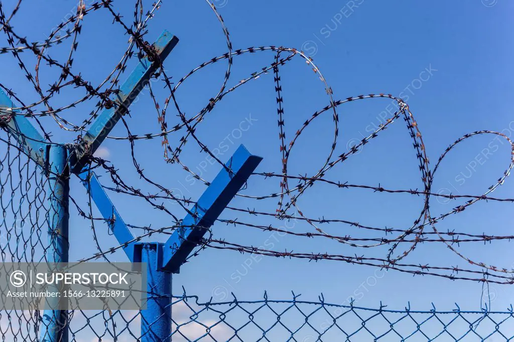 Razor wire and fence.