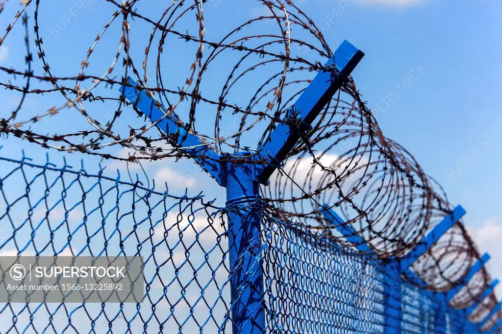 Razor wire and fence.