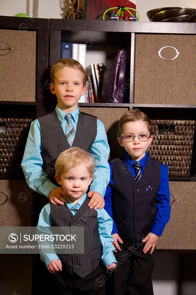 Three brothers pose in their dress-up clothes.
