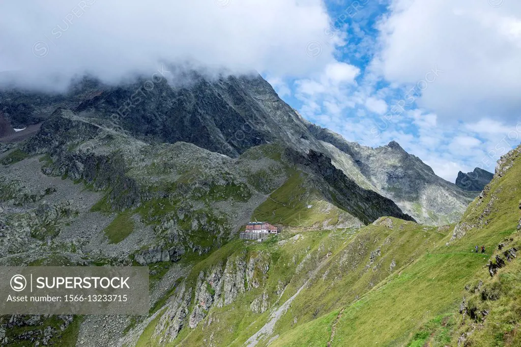 Stubai Alps, Tyrol, Austria. The Innsbrucker Hut, while the peak of the Habicht in the background is veiled by clouds.