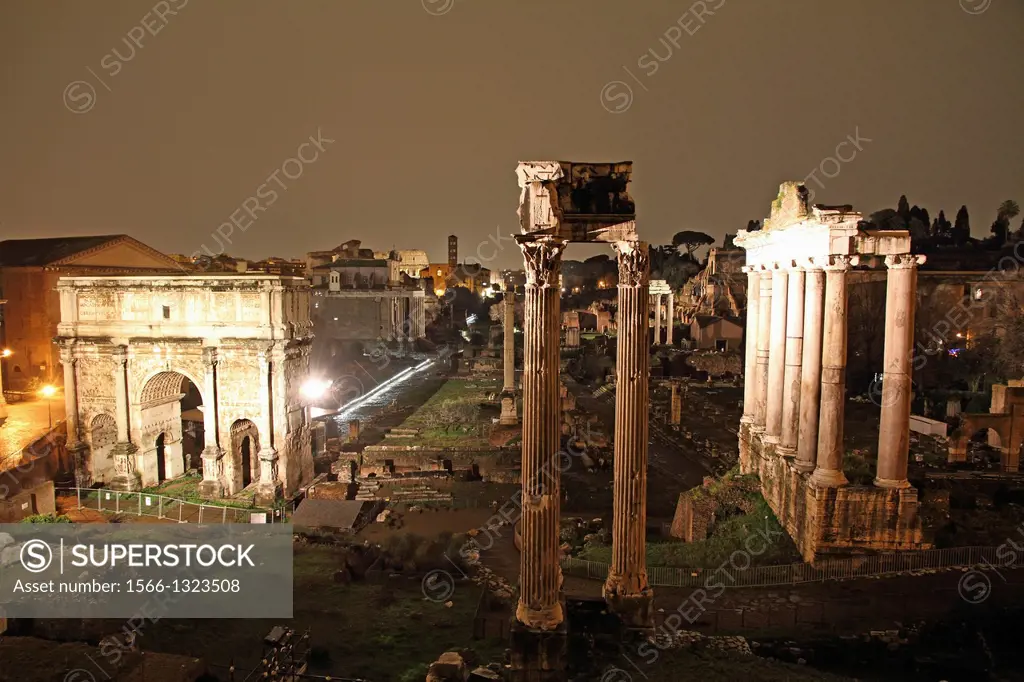 The columns of the Temple of Saturn, Arch of Septimius Severus and the medieval church in the Roman Forum, Rome, Italy.