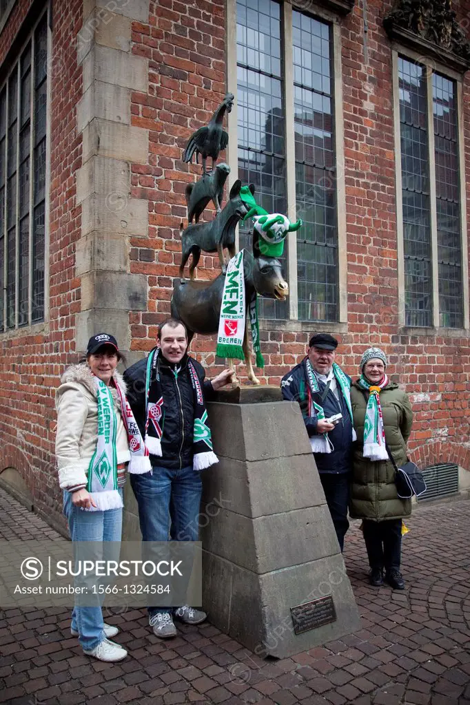 Fans of the local football team of Bremen at the statue of the Bremen Town Musicians. Bremen, Germany, Europe.