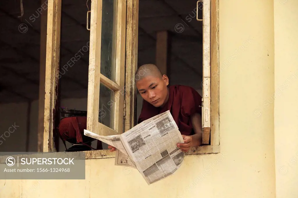 A young Buddhist Monk Reading, yangon, Burma