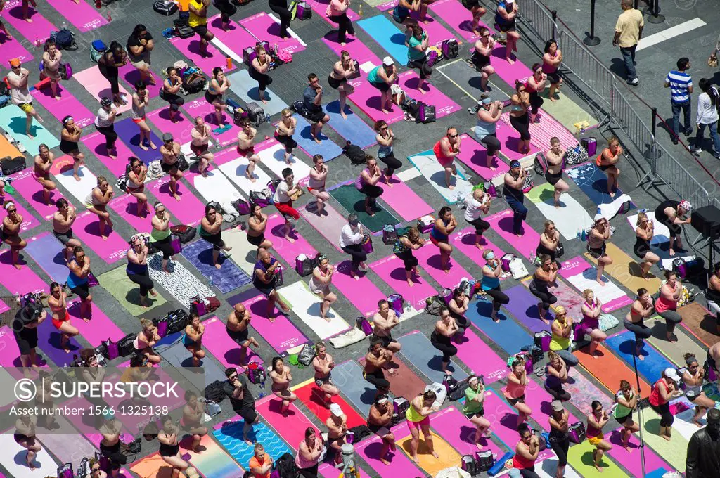 Thousands of yoga practitioners pack Times Square in New York to participate in a mid-day Bikram Yoga class on the first day of summer. The 11th annua...