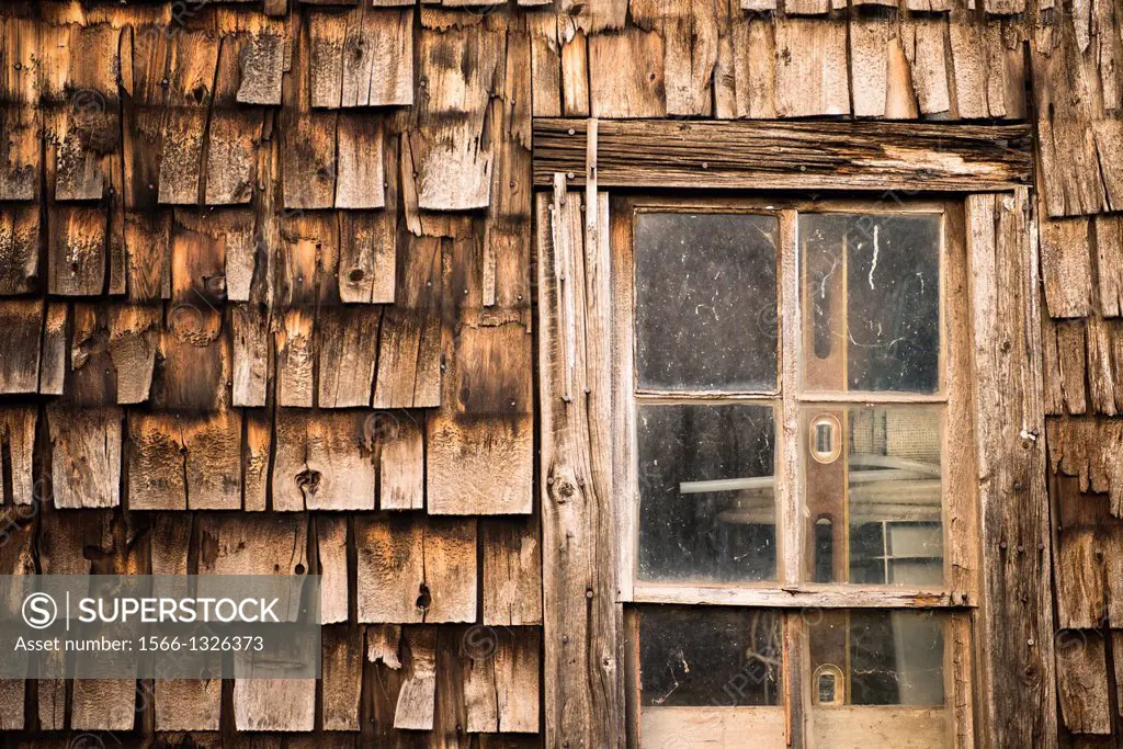 Wall of an old building sided with cedar shakes in Grand Marais, Minnesota, USA.