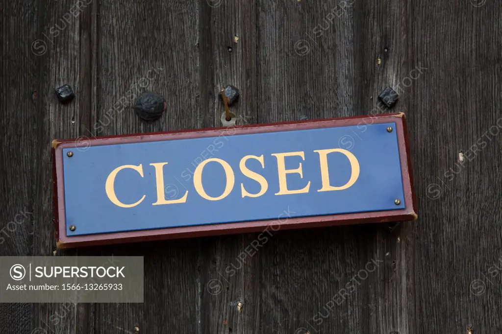 Closed Sign on Wooden Door.