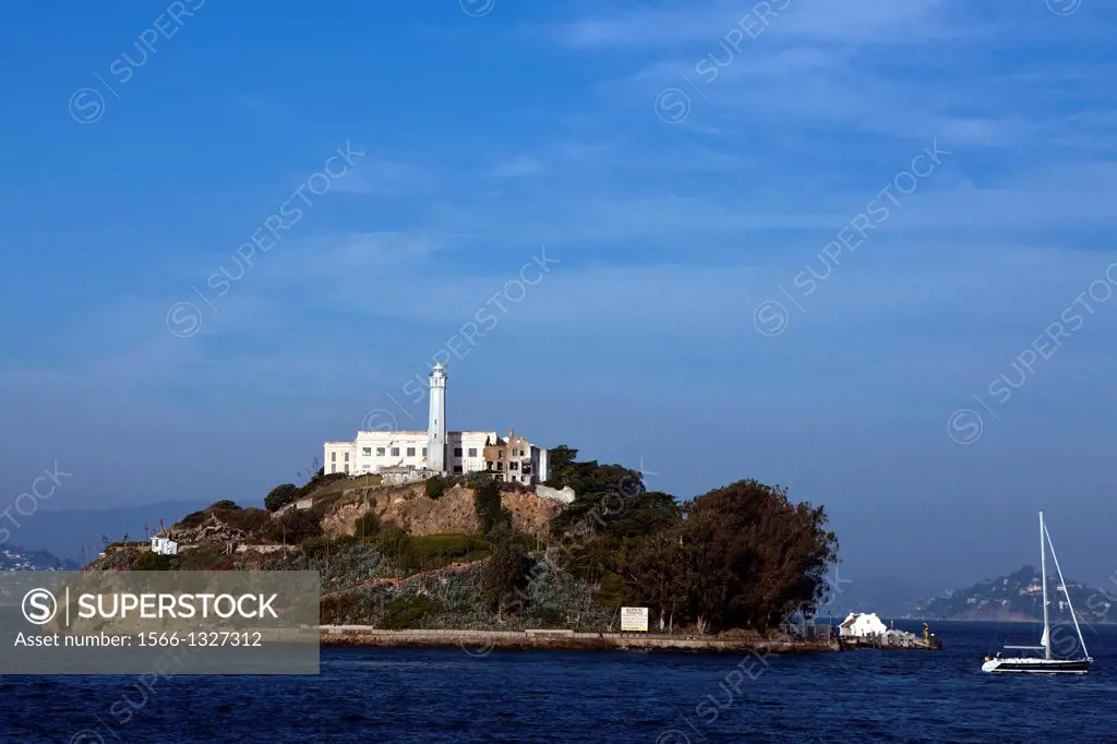 Alcatraz Island with sailboat passing by, San Francisco, California, United States of America.