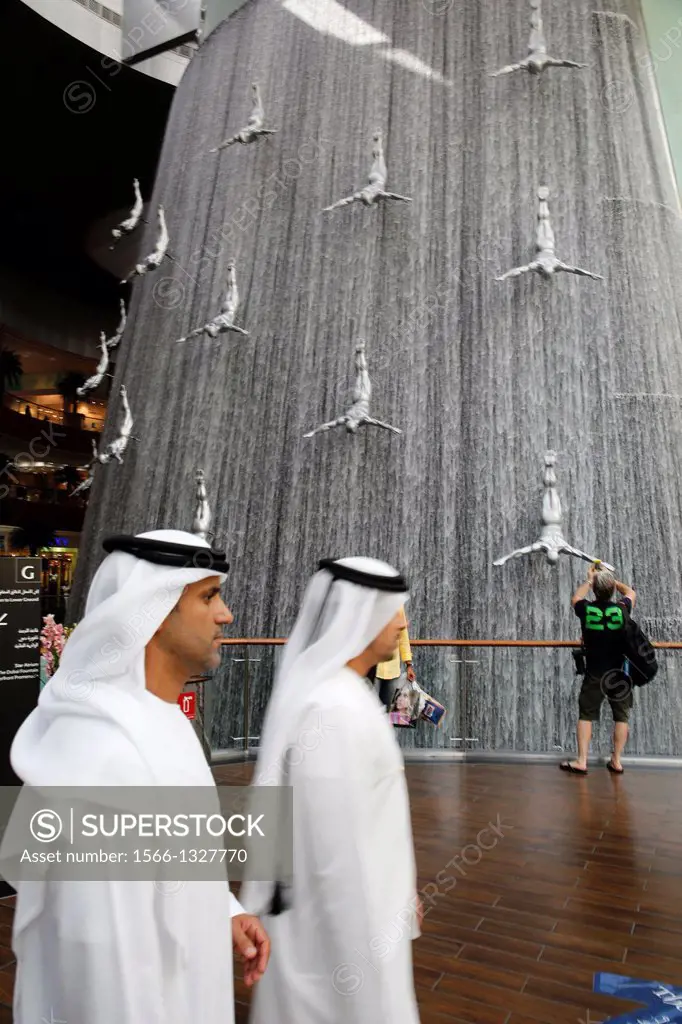 United Arab Emirates (UAE), Dubai, the Dubai Mall largest commercial center mall in the world with 1200 shops, interior waterall with sculptures of su...