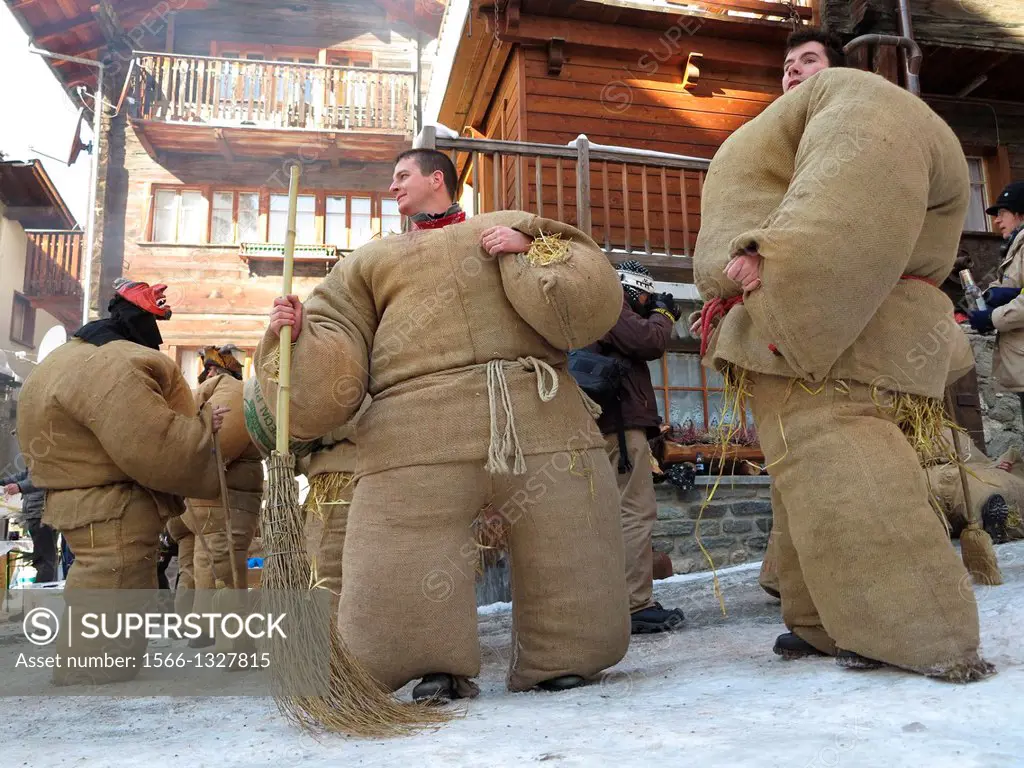 Switzerland, Valais, Herens valley, Evolene, Mardi Gras carnival, tradition of the disguised men with bags stuffed with 30 kgs of straw