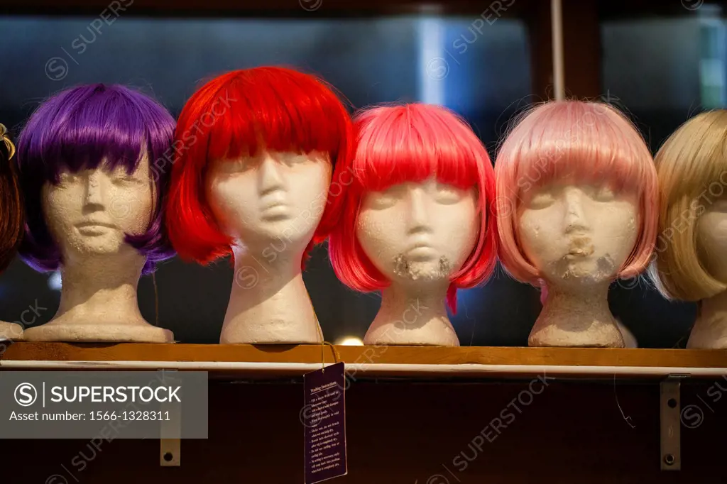 Brightly colored wigs on plastic mannequin heads for sale in a window in fabled 1960's counter culture location in the Haight-Ashbury section of San F...