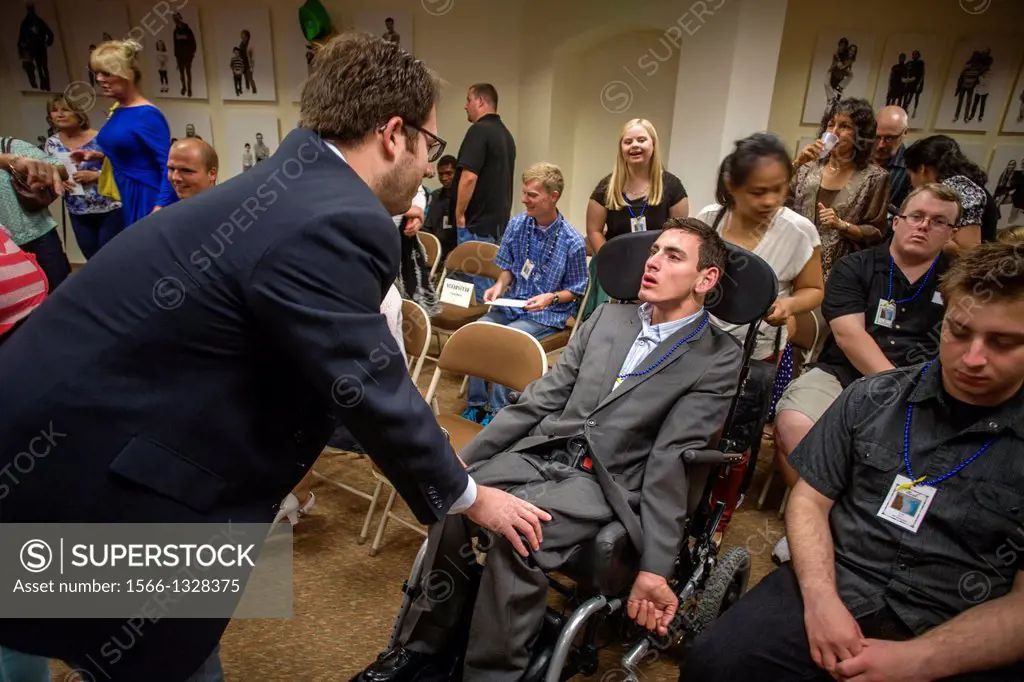 A wheelchair-bound Adult Transition Program (ATP) student is welcomed by guests at his graduation in San Juan Capistrano, CA. The ATP combines classes...