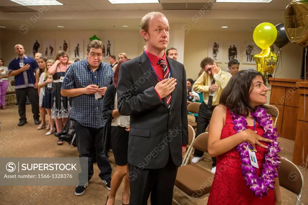 Adult Transition Program (ATP) students recite the Pledge of Allegiance at their graduation in San Juan Capistrano, CA. The ATP combines classes and c...