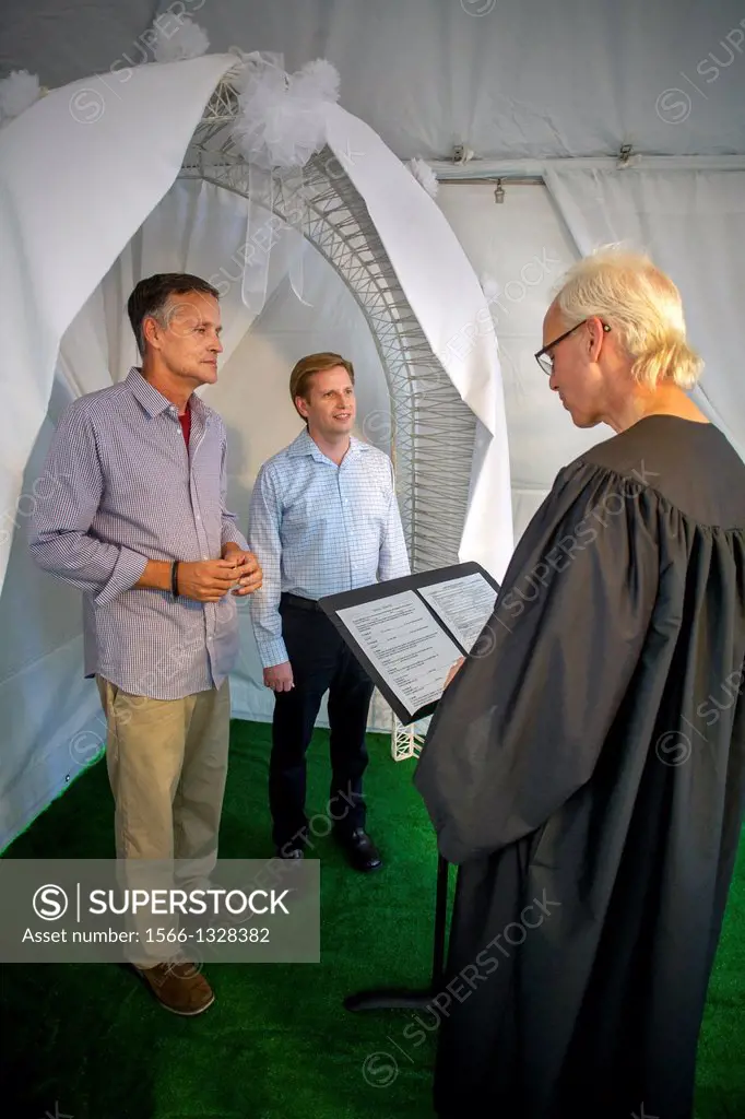 A Deputy Commissioner of Civil Marriages in West Hollywood, CA, officiates at a civil marriage ceremony for a gay male couple. A US Supreme Court deci...