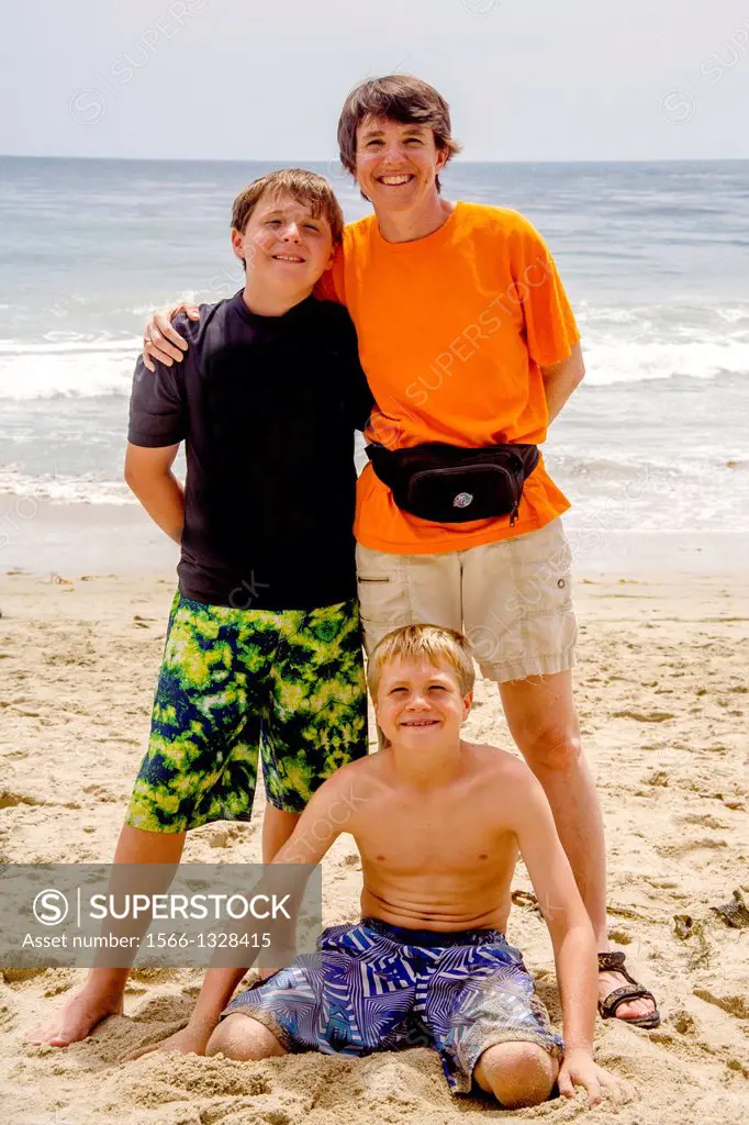 A California mother and her two adolescent sons pose on a summer afternoon at Laguna Beach, CA.