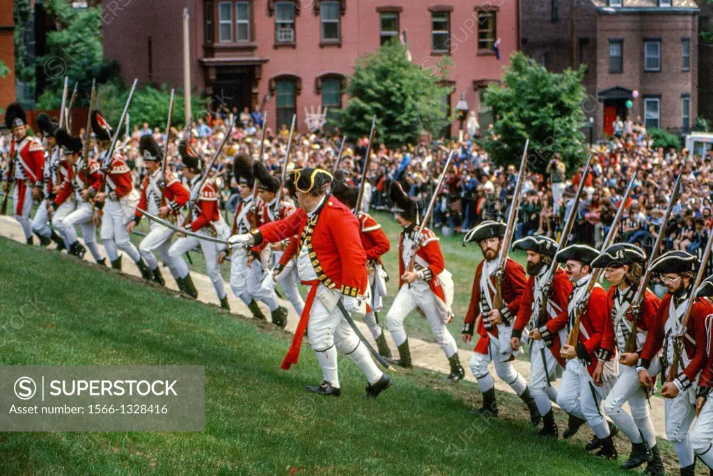 As spectators watch, British ""redcoat"" soldiers march against ""patriots"" defending their fortifications in a reenactment of the June 17 1775 Battl...